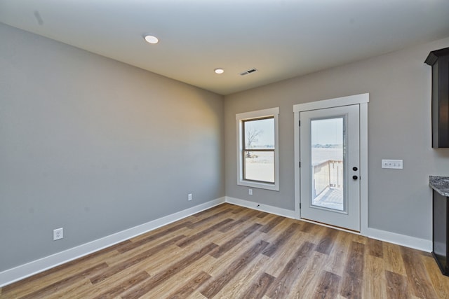 doorway to outside with wood-type flooring