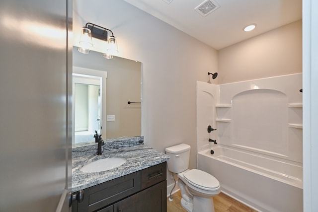 full bathroom with bathtub / shower combination, hardwood / wood-style floors, vanity, and toilet