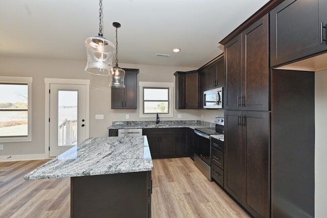 kitchen with a center island, sink, light hardwood / wood-style flooring, appliances with stainless steel finishes, and dark brown cabinetry