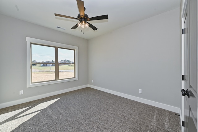 empty room with ceiling fan and dark carpet