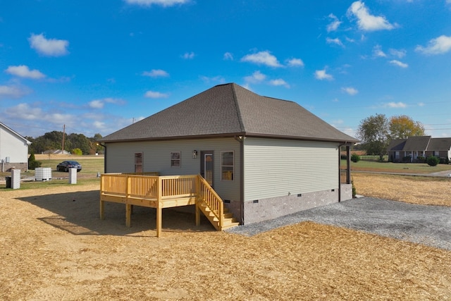 back of property featuring a wooden deck