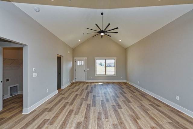 unfurnished living room featuring ceiling fan, light hardwood / wood-style floors, and high vaulted ceiling