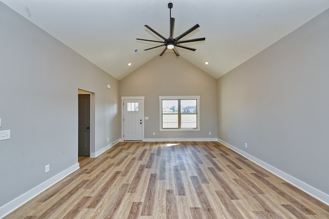 unfurnished living room with ceiling fan, light wood-type flooring, and high vaulted ceiling