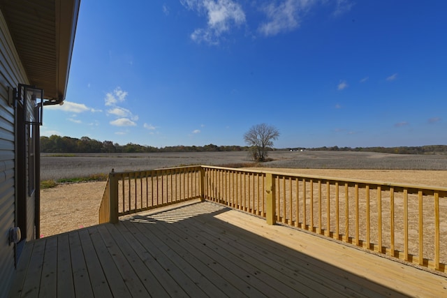 wooden deck with a rural view