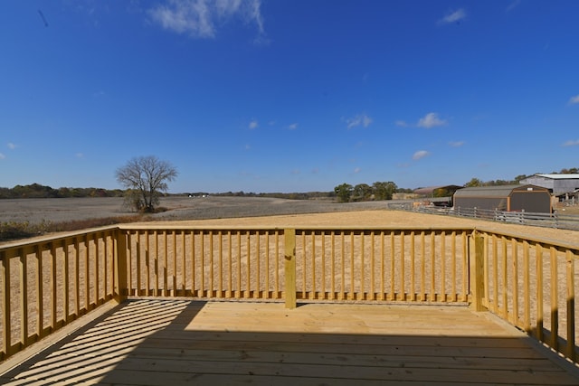 wooden terrace with a storage shed