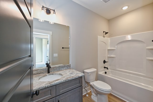 full bathroom featuring shower / washtub combination, vanity, wood-type flooring, and toilet