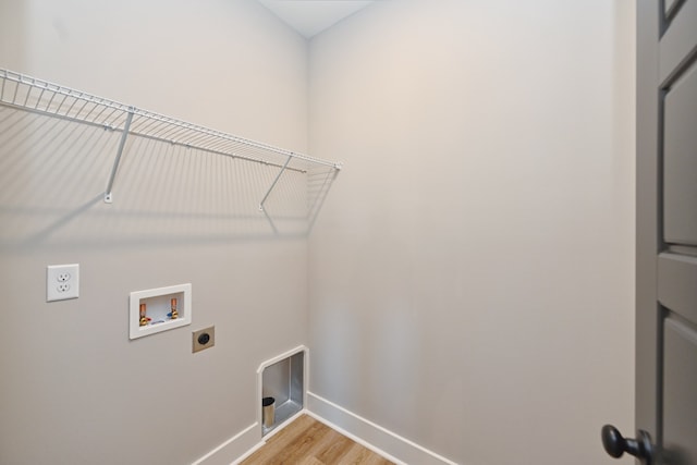 clothes washing area with washer hookup, electric dryer hookup, and light wood-type flooring