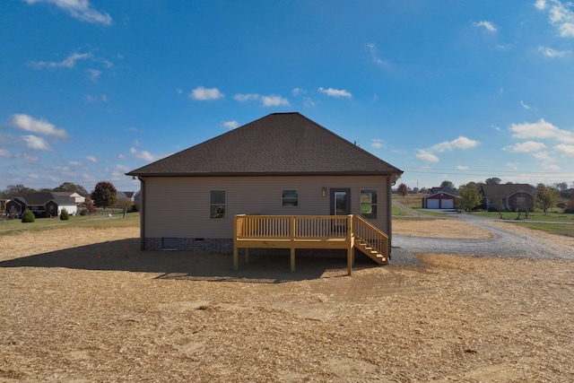 back of property with a wooden deck