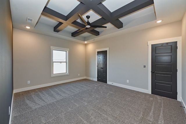 carpeted spare room featuring beamed ceiling, ceiling fan, and coffered ceiling