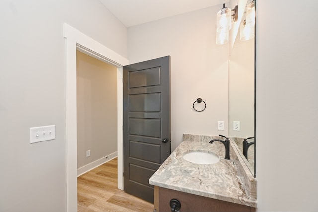 bathroom with hardwood / wood-style floors and vanity