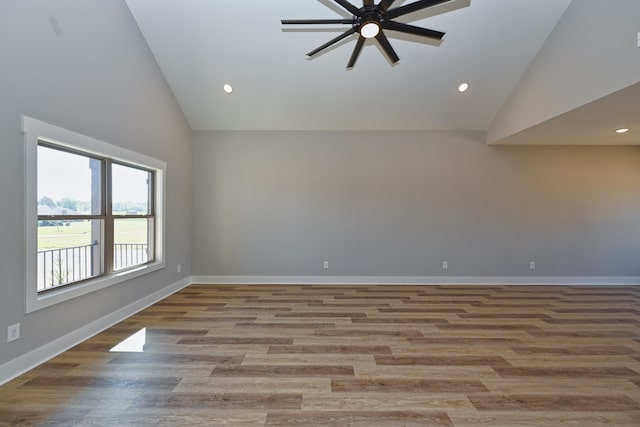 unfurnished room with ceiling fan, high vaulted ceiling, and light hardwood / wood-style floors