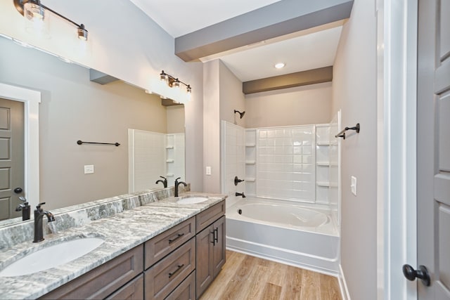 bathroom featuring hardwood / wood-style floors, vanity, and  shower combination