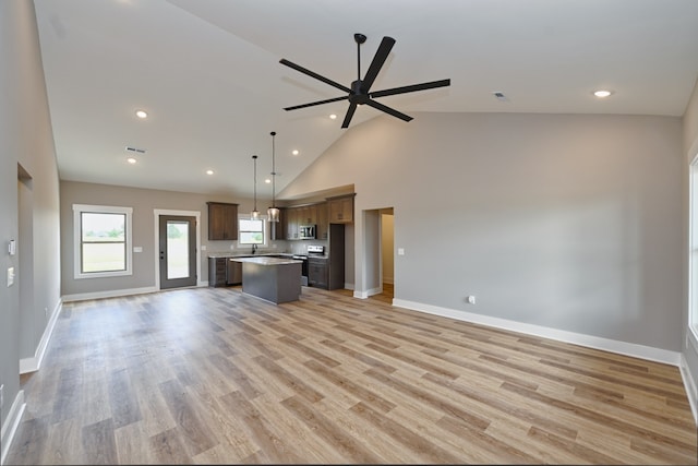 unfurnished living room featuring ceiling fan, high vaulted ceiling, and light hardwood / wood-style flooring