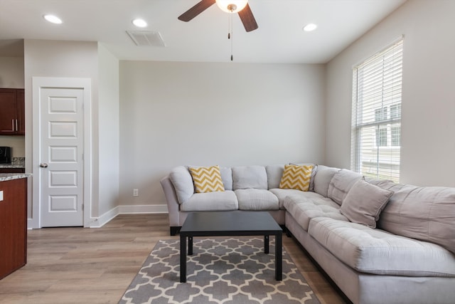 living room with ceiling fan and light wood-type flooring