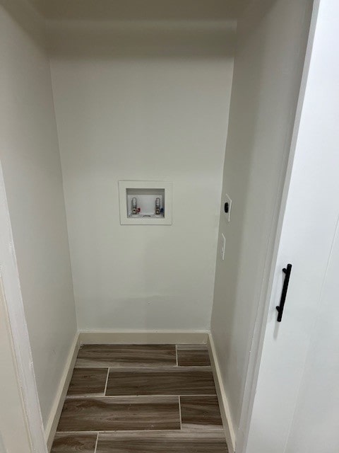 laundry room with electric dryer hookup, dark hardwood / wood-style flooring, and hookup for a washing machine