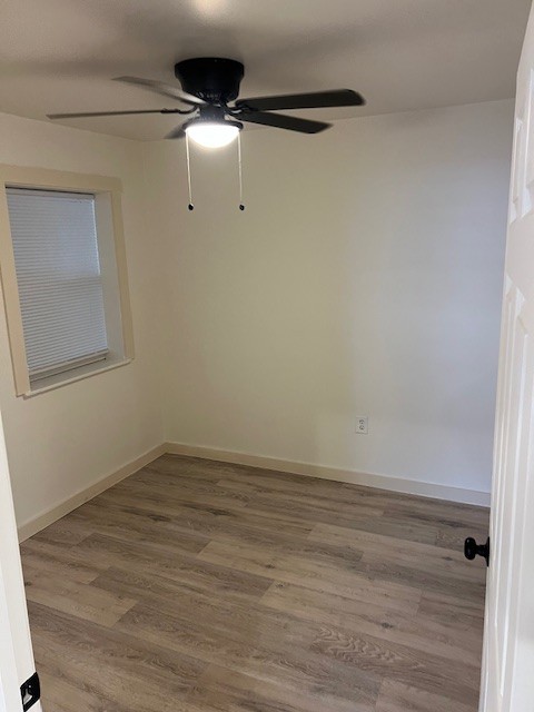 unfurnished room featuring ceiling fan and wood-type flooring