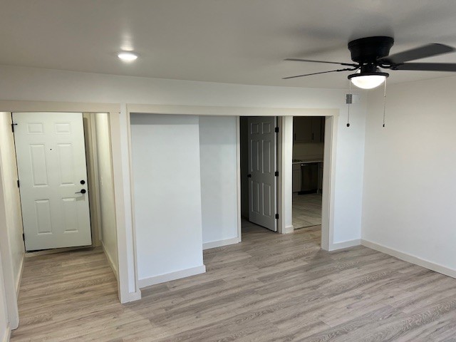 spare room with light hardwood / wood-style flooring and ceiling fan