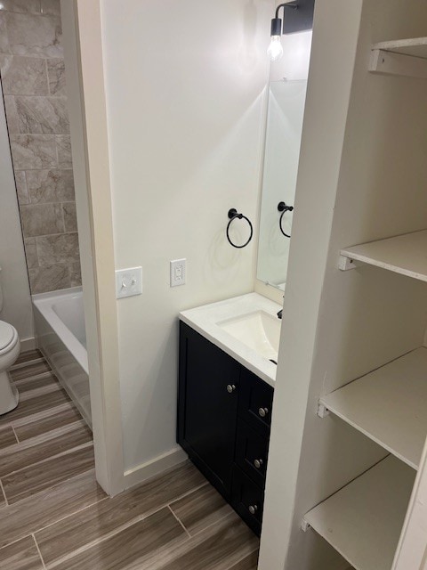 full bathroom with vanity, shower / bathtub combination, and toilet