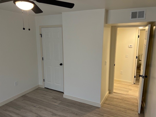 unfurnished room featuring ceiling fan and light hardwood / wood-style flooring