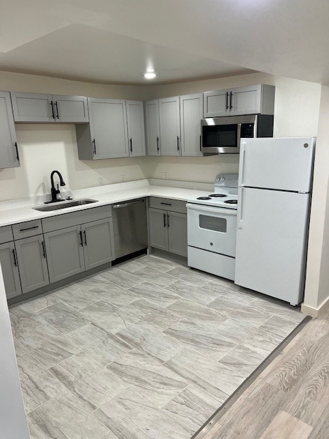 kitchen featuring gray cabinetry, sink, and stainless steel appliances