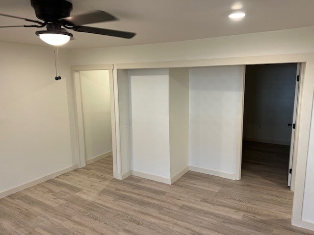 interior space featuring ceiling fan, light hardwood / wood-style floors, and a closet