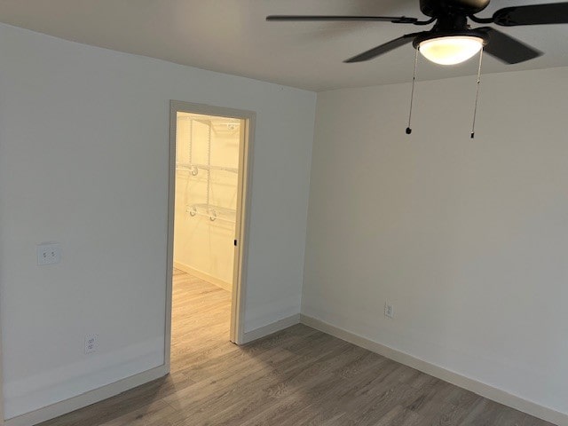 empty room with hardwood / wood-style flooring and ceiling fan