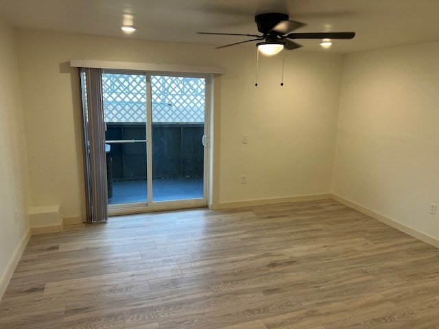 unfurnished room with ceiling fan and light wood-type flooring