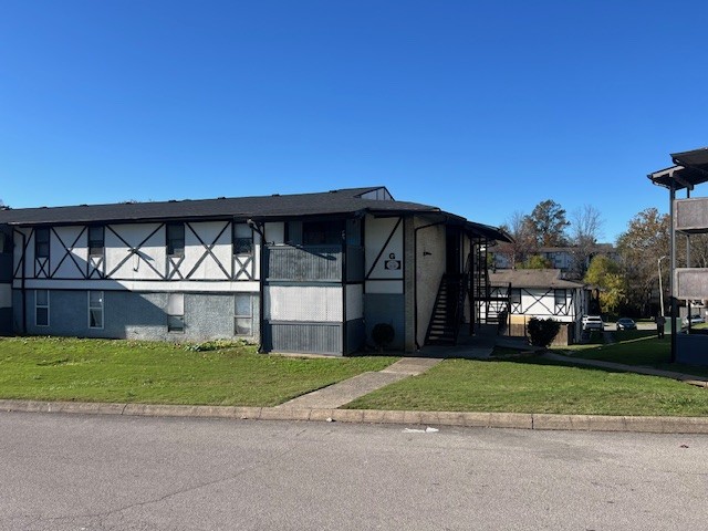 view of side of home featuring a yard