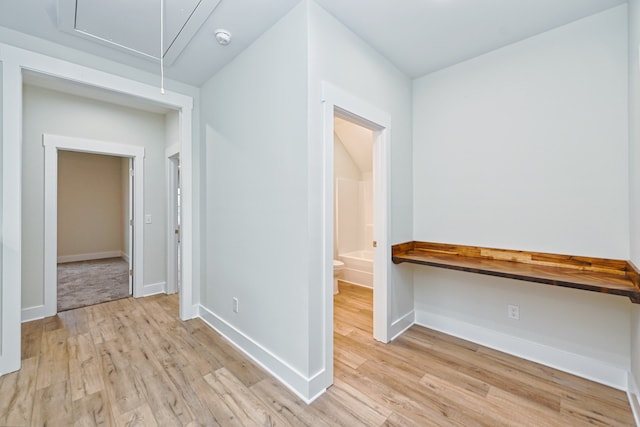 corridor with light hardwood / wood-style floors