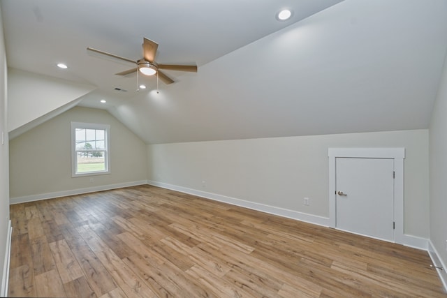 additional living space featuring ceiling fan, light hardwood / wood-style floors, and vaulted ceiling