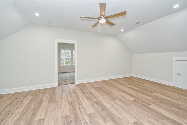 additional living space with ceiling fan, vaulted ceiling, and light hardwood / wood-style flooring