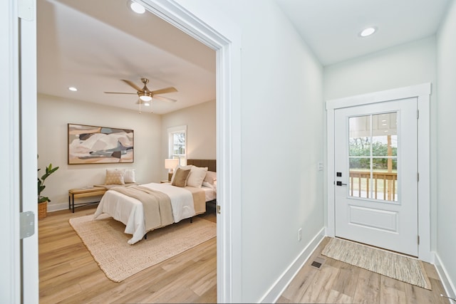 bedroom with ceiling fan and light hardwood / wood-style flooring