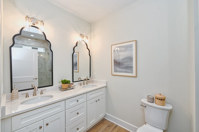 bathroom with a shower, vanity, hardwood / wood-style flooring, and toilet