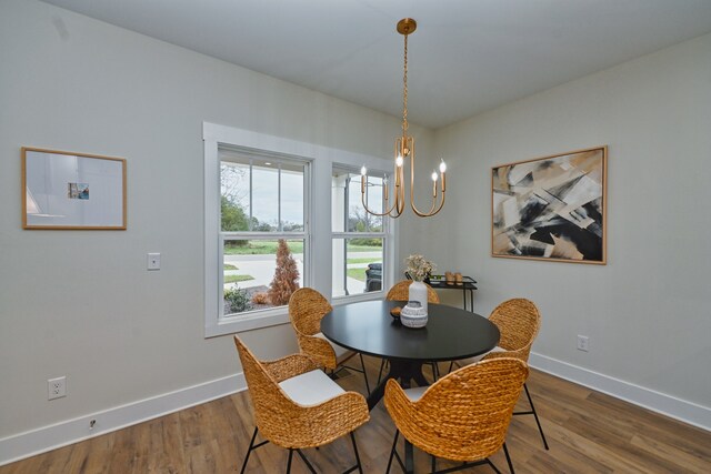 dining area featuring hardwood / wood-style flooring and a chandelier