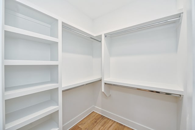 spacious closet featuring hardwood / wood-style floors