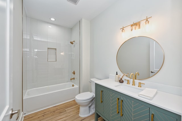 full bathroom with wood-type flooring, vanity, toilet, and tiled shower / bath