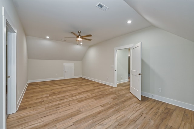 additional living space featuring ceiling fan, light wood-type flooring, and vaulted ceiling