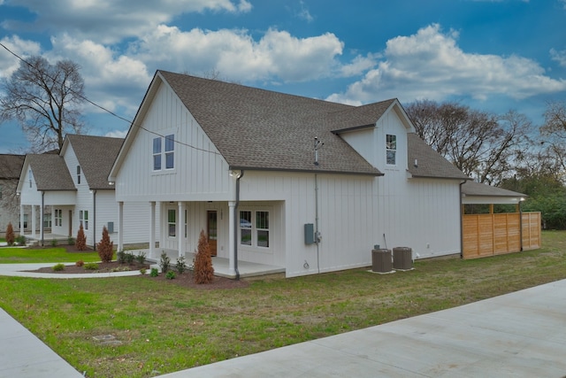 view of side of property with a yard and central air condition unit