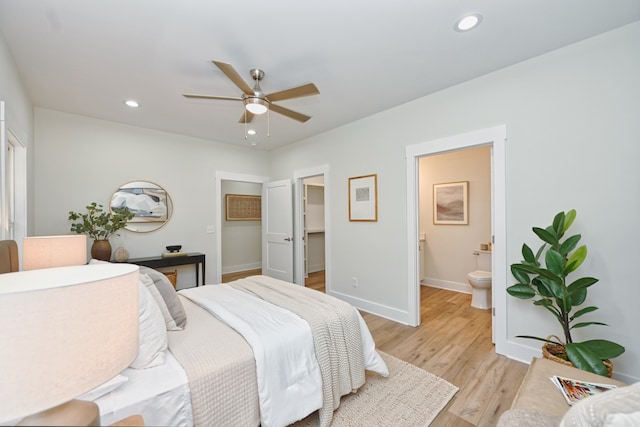 bedroom featuring connected bathroom, ceiling fan, and light hardwood / wood-style flooring