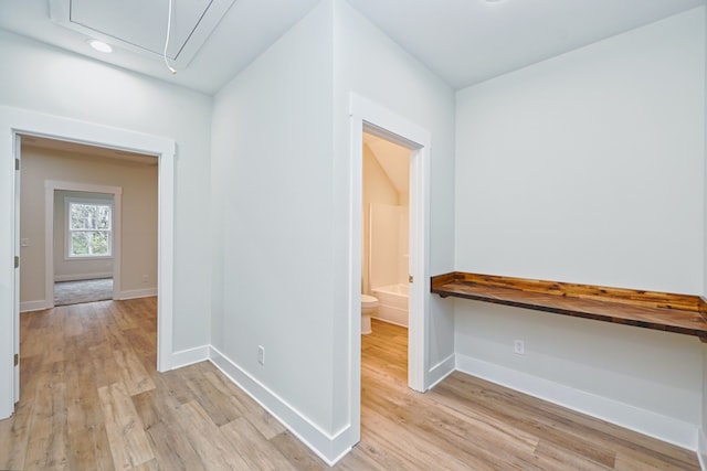 hallway with light hardwood / wood-style flooring