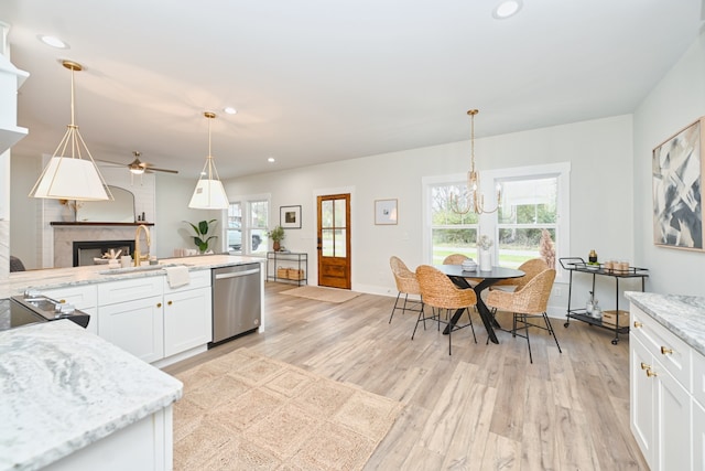 kitchen with dishwasher, light stone counters, light hardwood / wood-style flooring, pendant lighting, and white cabinets