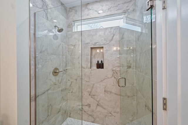 bathroom featuring a shower with shower door