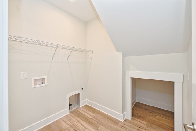 clothes washing area with hardwood / wood-style flooring, hookup for an electric dryer, and hookup for a washing machine