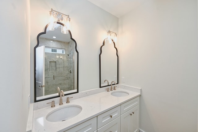 bathroom featuring vanity and a shower with door