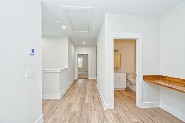 hallway featuring light hardwood / wood-style flooring and sink