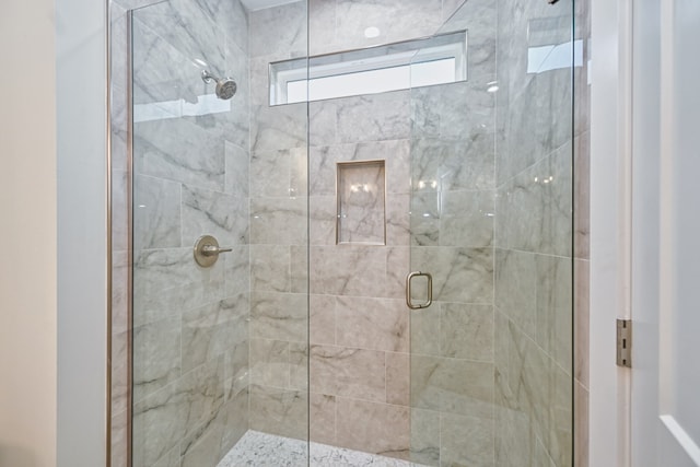 bathroom featuring a shower with shower door