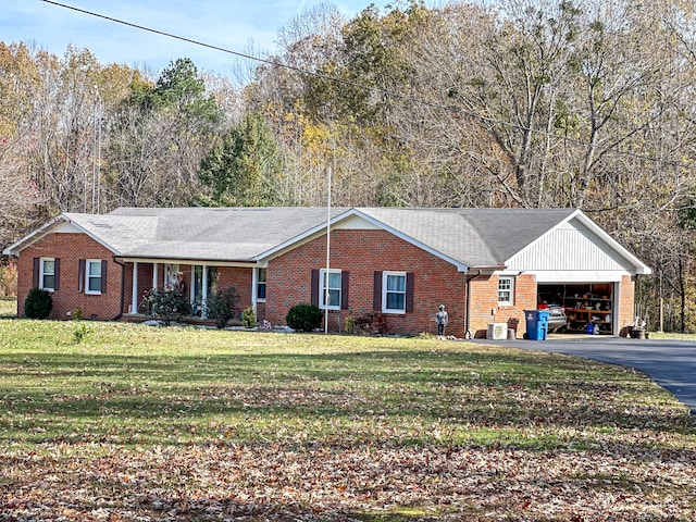 ranch-style house with a front lawn, brick siding, a garage, and aphalt driveway