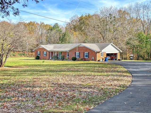 single story home with brick siding and a front yard