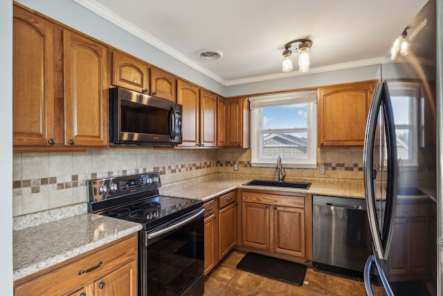 kitchen featuring crown molding, sink, tile patterned flooring, light stone counters, and stainless steel appliances