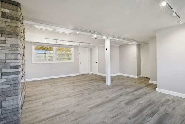 interior space featuring rail lighting and light wood-type flooring